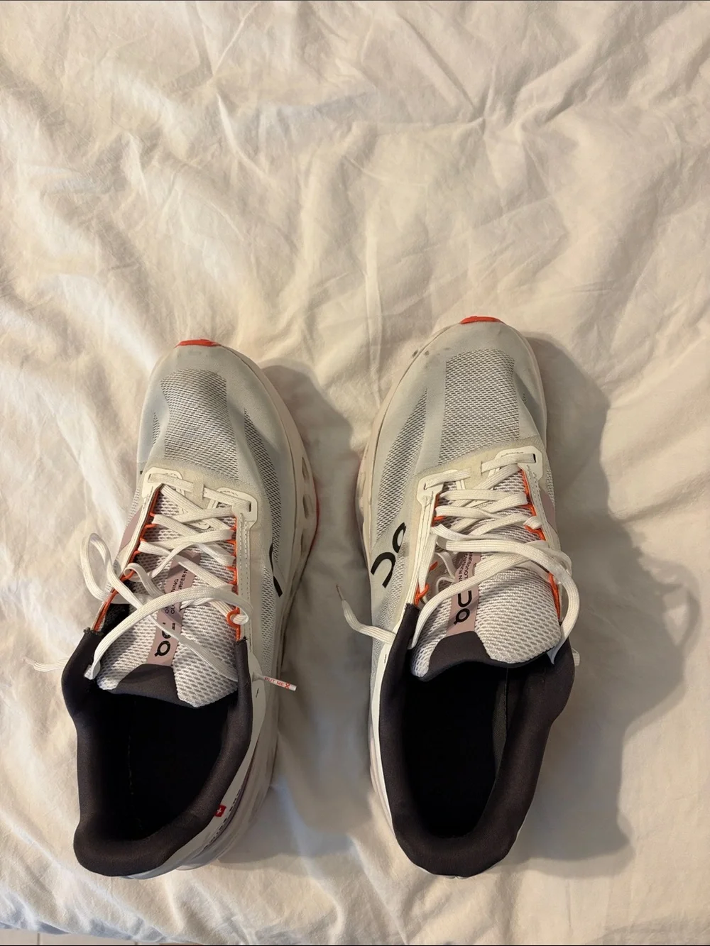 On Running Mens White Sneakers with Orange Accents